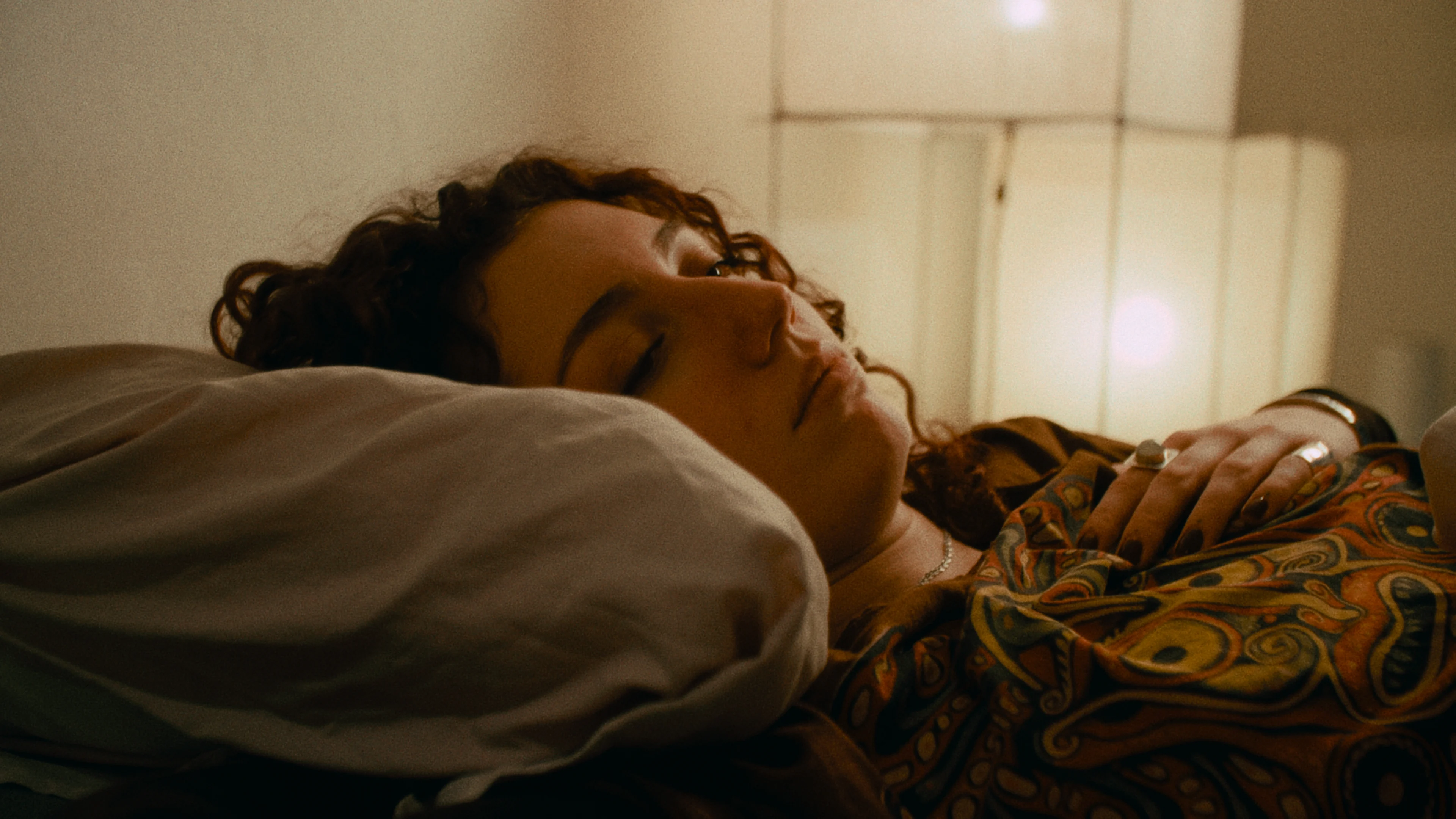 A woman rests in warm late-afternoon light.
