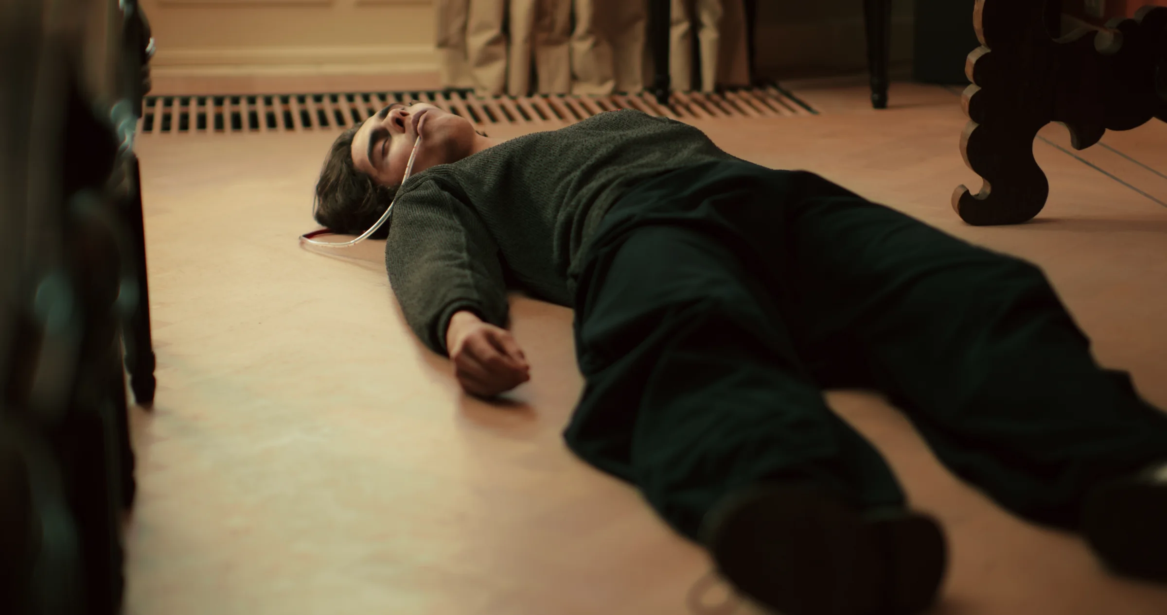 A person lies on the floor of a room.