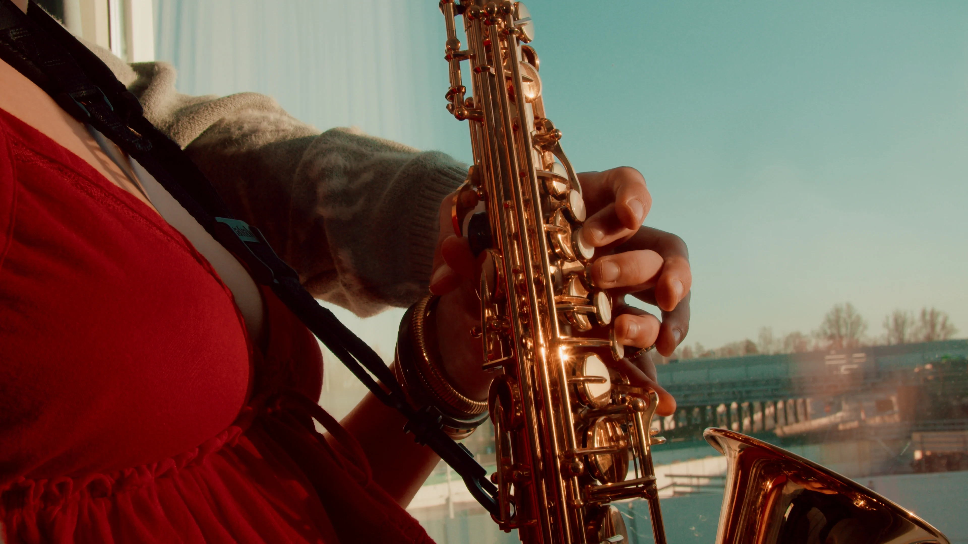 A musician performs in a warmly lit room.