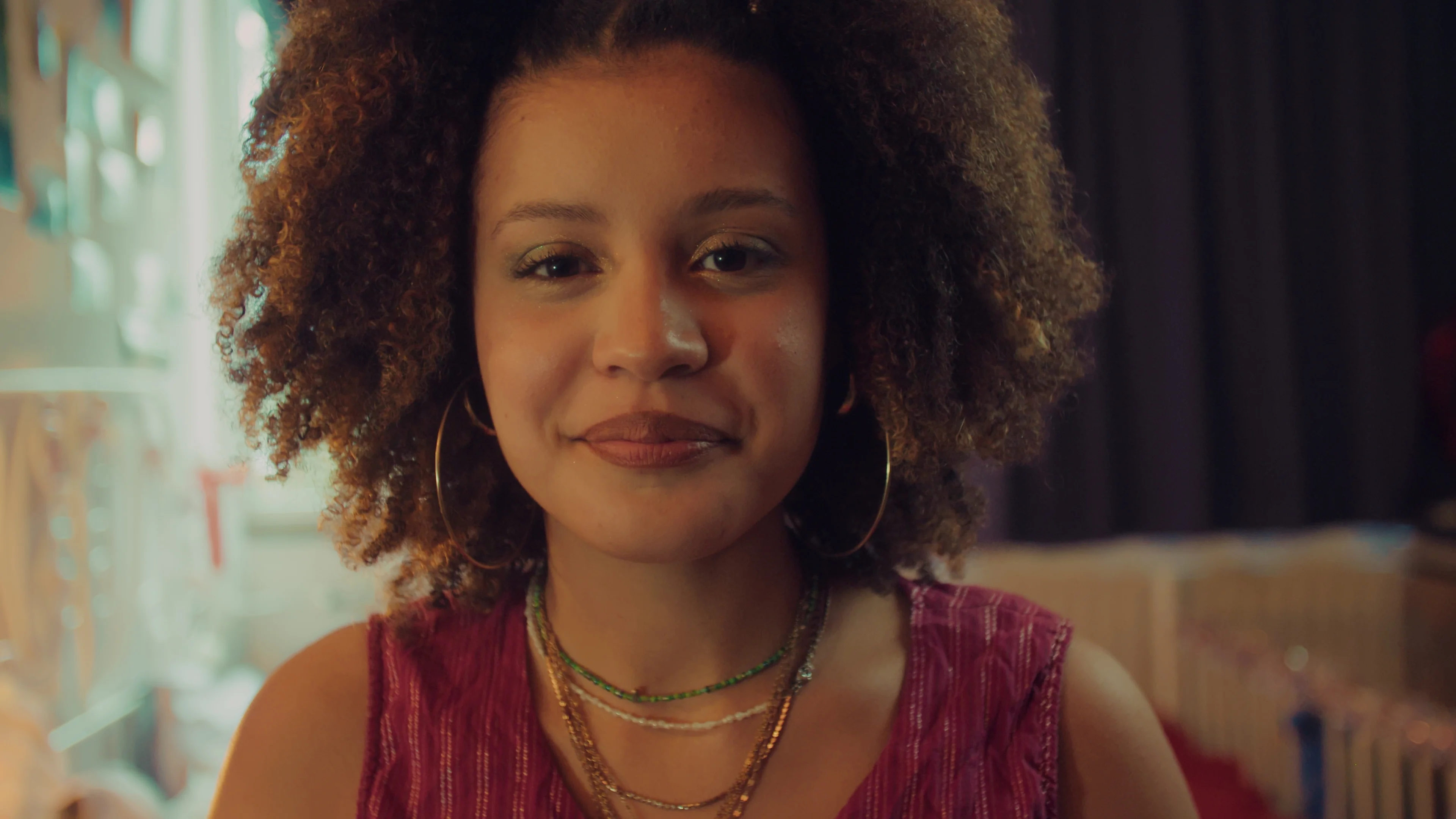 A calm portrait in a warmly lit room.
